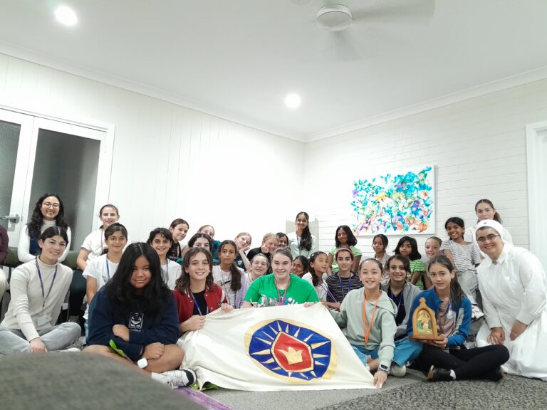 A Schoenstatt girls' and young women's group gathered with their banner