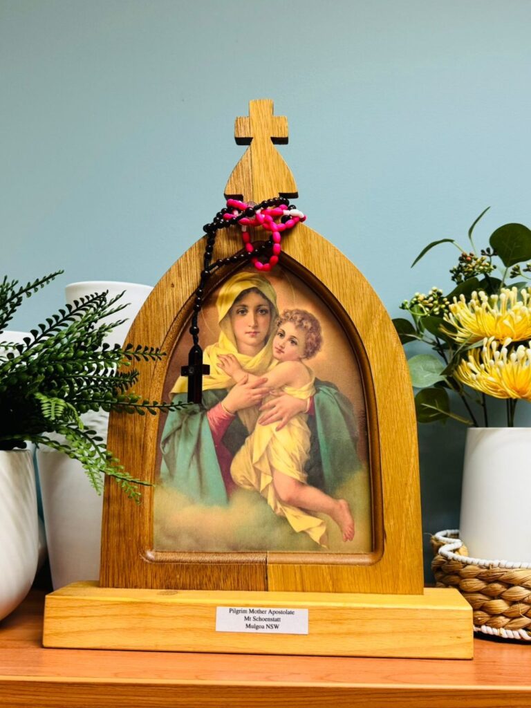The Pilgrim Mother shrine with the Mother Thrice Admirable picture and a rosary, set up in a home