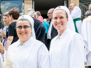 Two young Schoenstatt Sisters of Mary at a community celebration